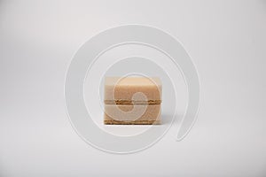 Two beige sponges for washing dishes on a white background