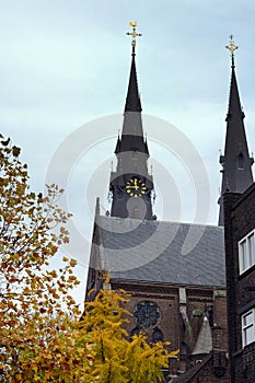 Two belfries of the Catholic Church of St. Catherine, Eindhoven, Netherlands. Golden Autumn in Eindhoven