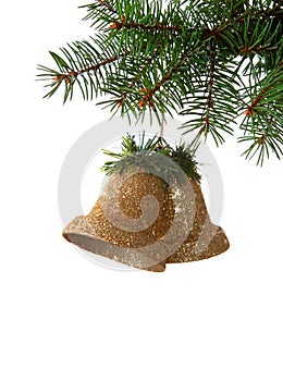 Two bells hanging on a spruce