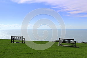 Two benches on green English channel viewpoint