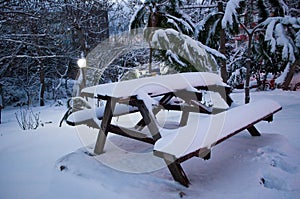 Snow covered picnic table and benches during winter
