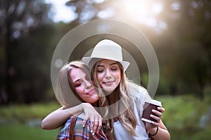 Two best female friends hugging outdoors