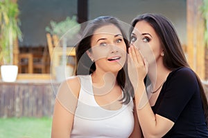 Two Best Friend Girls Whispering a Secret photo
