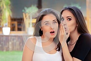 Two Best Friend Girls Whispering a Secret photo