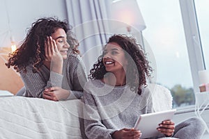 Two best friends having good mood while chatting with each other