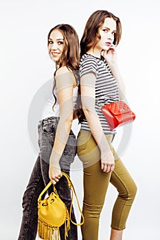 Two best friends teenage girls together having fun, posing emotional on white background, besties happy smiling