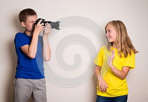 Two best friends teens making photo on their camera at home, having fun together, joy and happiness