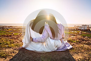 Two best girlfriends or sisters hugging and enjoying life at sunset. Friends spending time together. Friends forever