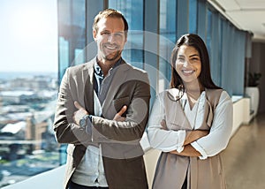 Two is always better than one in the business world. Portrait of two businesspeople standing with their arms crossed in