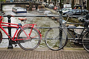 Two bicycles on a bridge over a canal in Amsterdam, Netherlands