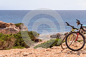 Two bicycles by a hidden beach in Ibiza, Balearic Islands. Spain