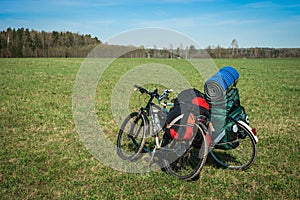 Two bicycles with luggage on meadow in Kaluga region, Russia