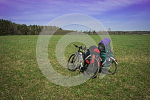 Two bicycles with luggage on meadow in Kaluga region, Russia