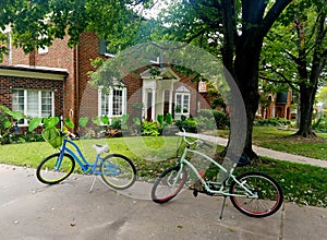 Two bicycles parked in front of upscale traditional home