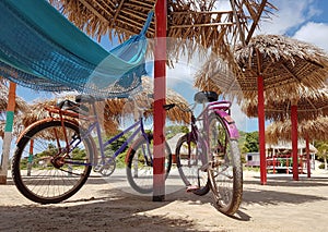 Two bicycles on the sand.