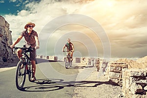 Two bicykle travelers on the mountain road in Himalaya