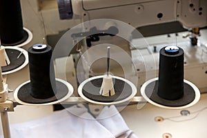 Two big black bobbins with large mating threads