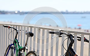 Two bikes parked along sea closeup. . Healthy lifestyle and cycling