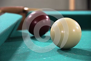 two billiard balls on green cloth table, cue ball and white ball. framing, russian billiards