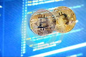 Golden shining bitcoin on a blue background