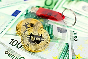 Two bitcoins and usb flash on the background of euro banknotes