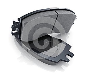 Two black brake pads on white background