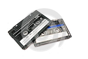 Two black cassettes on white background. Vintage audio tapes. Old-fashioned musical objects