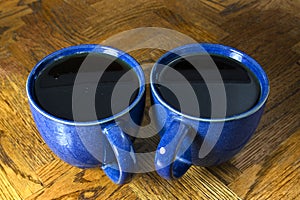 Two Black Coffees in Blue Mugs