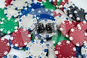 Two black dice on poker chips, top view. Casino concept