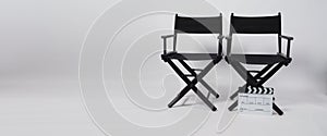 Two black director chair and clapper board use in video production or movie and cinema industry on white background