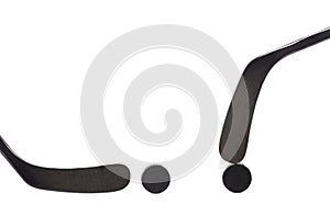 Two black ice hockey stick and puck.