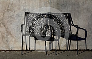 Two black rattan chairs in evening sun