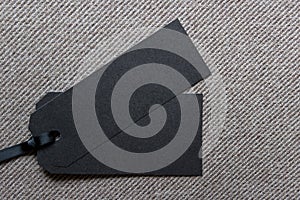 Two black sale tags labels on fabric