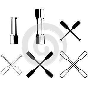 Two black silhouette of crossed oars. rowing oars sign. crossed wood paddle symbol. flat style