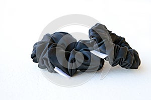 two black silk Scrunchy on white background. Hairdressing tool Elastic Hair Band, Bobble Hairband