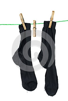 Two black socks hanging on rope photo