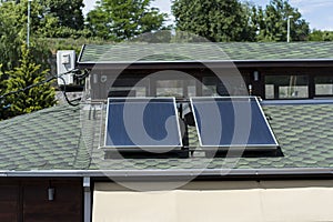 Harnessing the Power of Nature: Close-Up of Black Solar Panels on a Green Roof photo