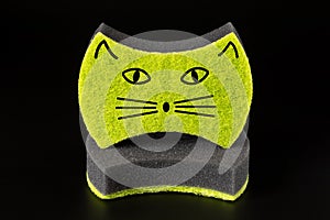Two black sponges for washing dishes and other domestic or household needs isolated on black background. Image of cat's