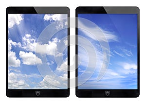 Two black tablet and blue sky background.