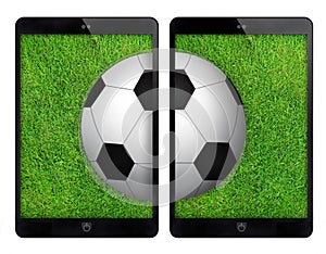 Two black tablet with soccer ball on green wall.