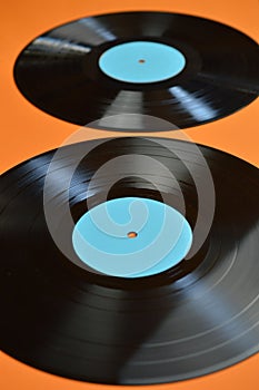 Two black vinyl record on orange