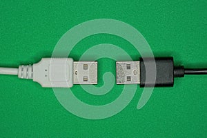 Two black white electric cables with plugs