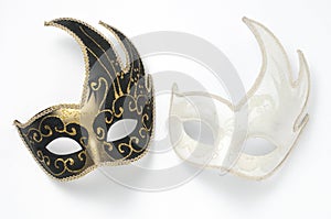 Two black and white theater or mardi gras venetian masks on white background