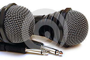 Two black wired karaoke microphones.