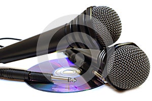 Two black wired karaoke microphones and CD.