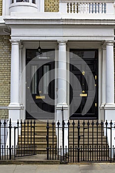 Two black Wooden Doors to residential building in London. Typical door in the English style