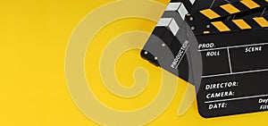 Two Black and yellow Clapper boards or movie slates. on yellow background.