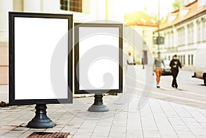 Two blank advertising billboards on the city street