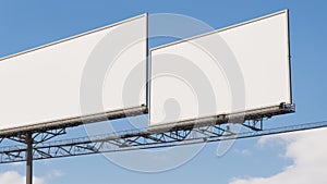 Two Blank Billboards Against Blue Sky