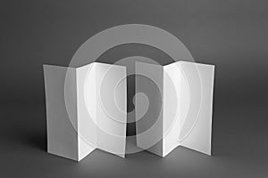 Two blank brochures on grey background. Mock up for design